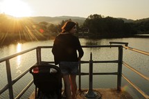 a mother and stroller on a dock 
