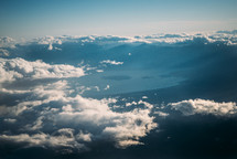 above the clouds over a mountain range