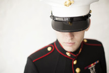 Marine in uniform looking down.