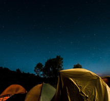 stars in the night sky over tents 