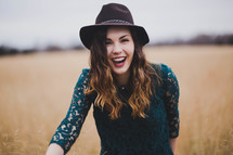 a joyful woman outdoors in a field 
