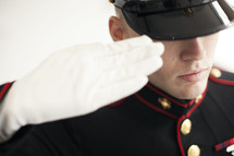 Closeup of Marine in uniform saluting.