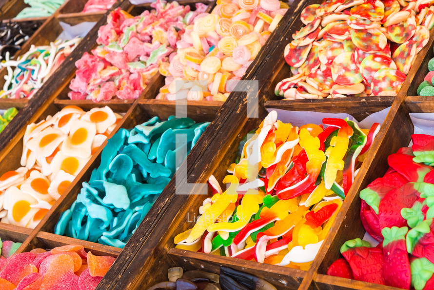 Many colorful candies on market stand