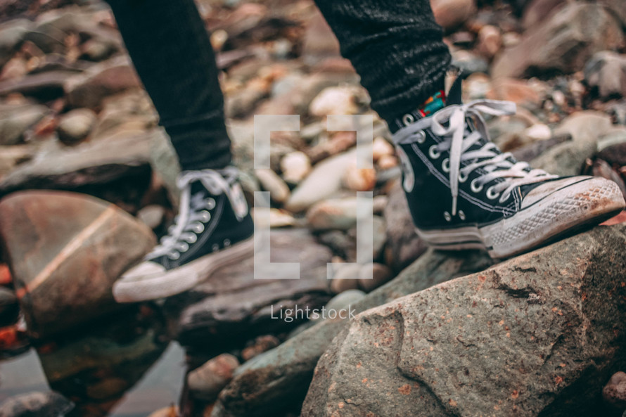 sneakers standing on rocks 