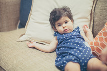 toddler girl resting on a couch 