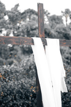 white shroud on a wooden cross 
