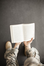 soldier reading a Bible 