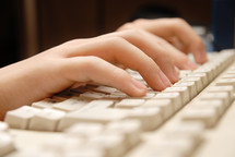  hands working on a keyboard in the internet