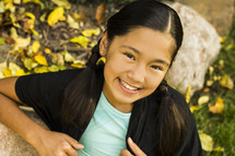 a smiling Asian girl posing for a portrait 