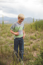 boy child holding a potted aloe plant 