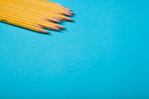 sharpened pencils on a blue background 