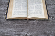 Old open french Bible open on wood