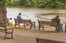 park benches at the edge of a river 