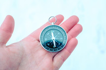 a compass in a hand 