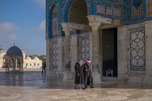 men walking near a mosque in Jerusalem 