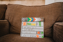 Film slate on a couch on set