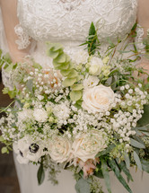 Close up of a bride holding her wedding bouquet.