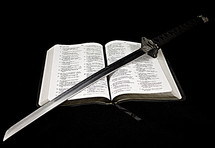sword lying on the pages of a Bible 