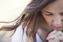 Closeup of a woman in reverent prayer.