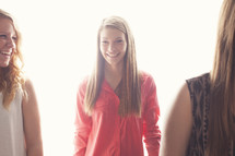 Young woman, standing with two other girls