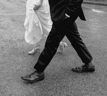 Close up of a bride and groom's legs walking.