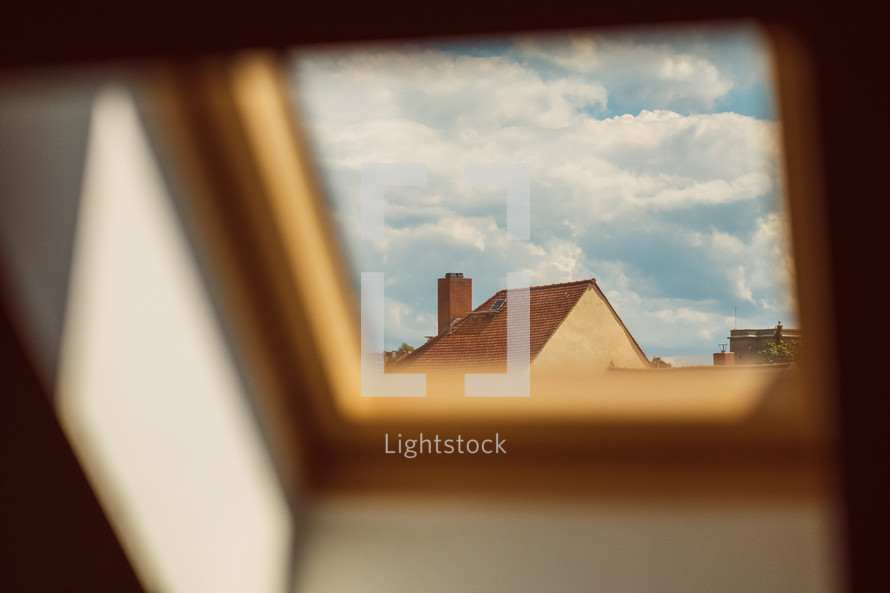 view of a house rooftop through a skylight window 