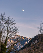 moon over a mountain peak 
