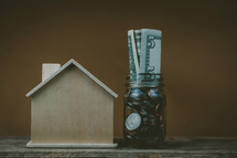 house and money in a jar 