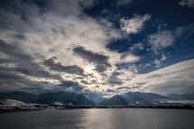 clouds and sunbeams over a lake 