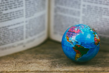 Bible pages and globe 