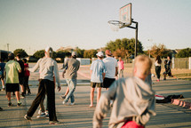 teens playing basketball 