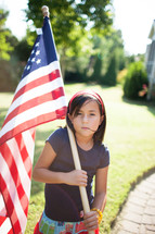 child holding an American flag