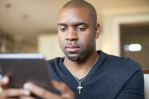 Man holding an electronic tablet.