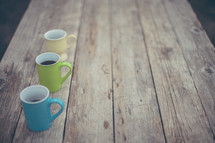 coffee mugs on a wood table 