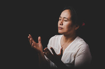 Asian woman praying to God