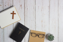 Bible and notebook on a white wood background 