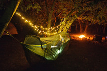 person reading in a hammock at night 