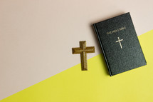cross, BIble, on a pink and yellow background 
