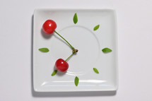 abstract cherry fruit clock isolated on plate, natural clock