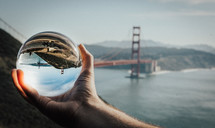 view of the Golden Gate Bridge through a glass orb