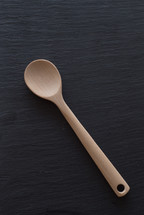 wood spoon on a black background 