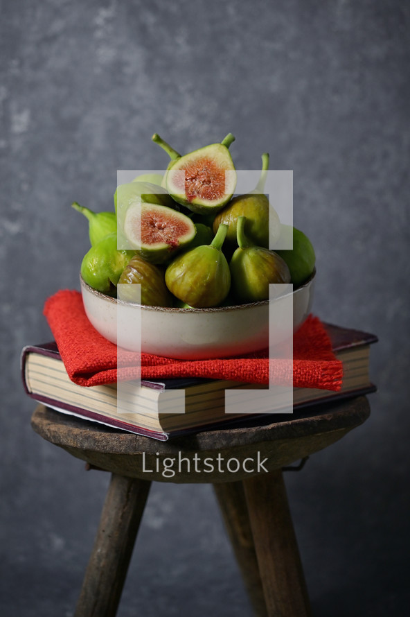 figs on a book on a stool 
