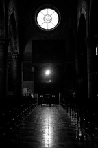 aisle and pews in a dark cathedral 