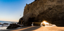 sunburst through a cave on a beach 
