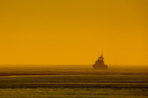 silhouette of a boat on ocean water 