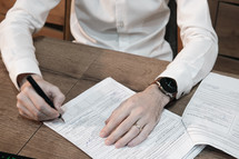 man signing a contract 