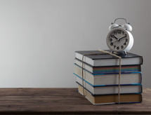 alarm clock on a stack of books