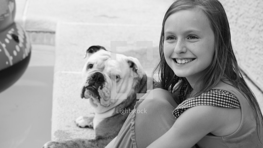 A smiling girl and her pet dog 