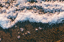 snow on the sand of a beach