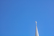 White steeple against bright blue sky background